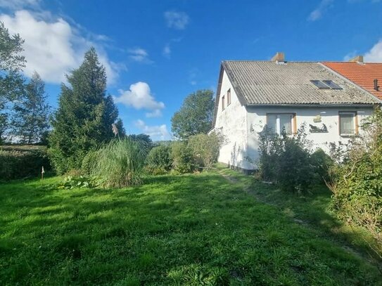 Doppelhaushälfte mit Nebengebäude und Garage auf großem Grundstück…