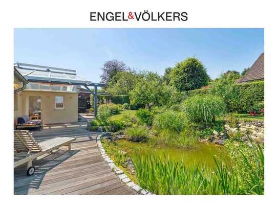 Engel & Völkers: Attraktiver Bungalow mit Traumgarten am Rand von Siegburg!