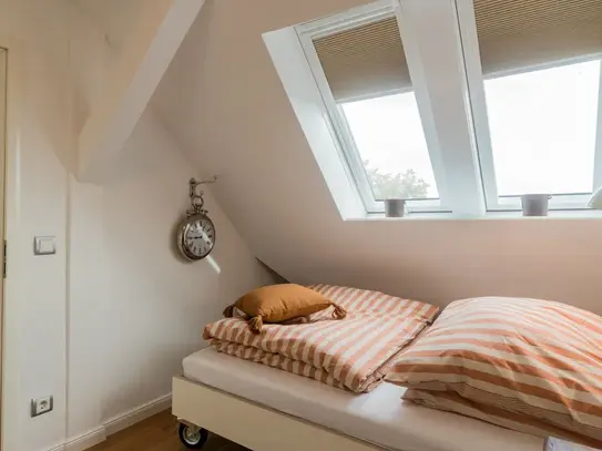 Light-flooded, modern two-room apartment in the developed attic of an early 20th century house