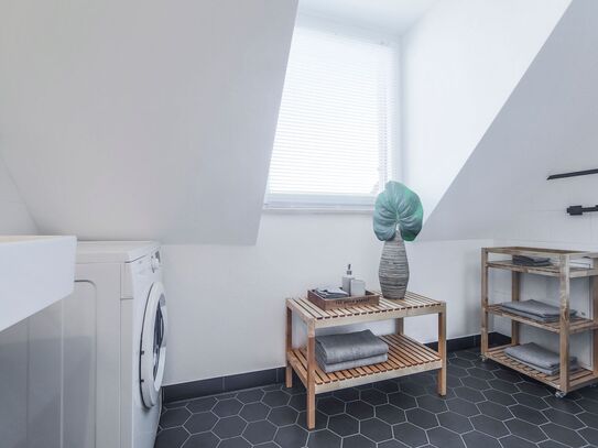 Above the roofs. Modern attic apartment in the zoo district