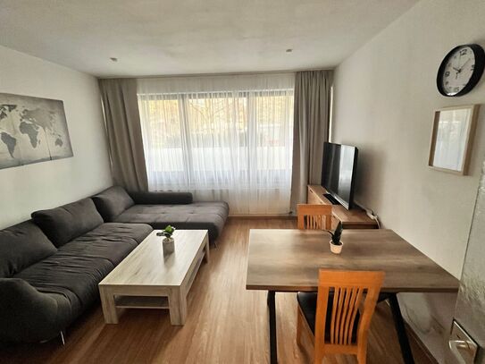 Fully furnished 2-room apartment with underground parking, smart TVs & quiet top location