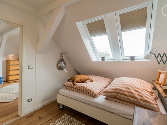 Light-flooded, modern two-room apartment in the developed attic of an early 20th century house