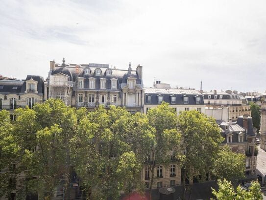 Parisian cocoon under the roofs with Eiffel Tower view