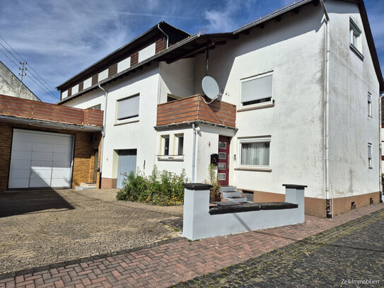 Zwei- bis Dreifamilienhaus mit Werkstatthalle und großer Terrasse zu verkaufen